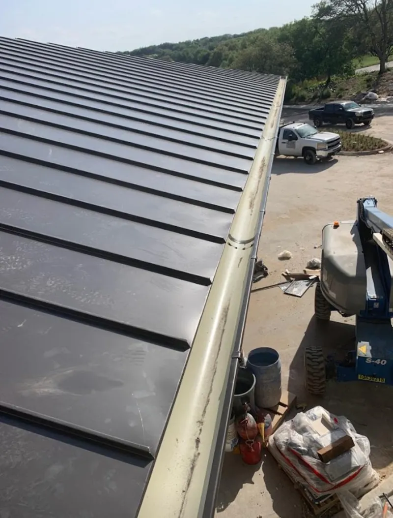 Standing seam panel and gutter detail on a metal roofing jobsite in Groveport